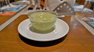 Pudina Dahi Chutney or Mint Yoghurt Dip kept in glass bown ready for serving with vegetarian or non vegetarian Tikka or barbecue foods.