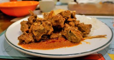 Closeup of Spicy Rogan josh mutton or goat curry with aromatic Basmati rice or Chawal