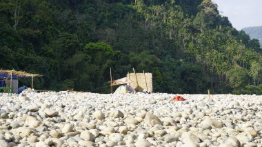 Beautiful camping tents for tourists in Dawki or Umngot River, located at Meghalaya,India with amazing scenic view of crystal clear water clipart