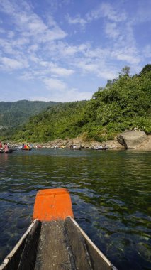 Dawki, Meghalaya,India-December 02 2023: Tourists boating in Dawki river Dawki or Umngot River, located at Meghalaya,India clipart