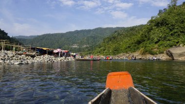 Dawki, Meghalaya,India-December 02 2023: Tourists boating in Dawki river Dawki or Umngot River, located at Meghalaya,India clipart