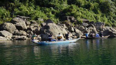 Dawki, Meghalaya,India-December 02 2023: Tourists boating in Dawki river Dawki or Umngot River, located at Meghalaya,India clipart