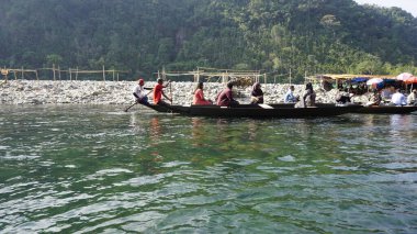 Dawki, Meghalaya,India-December 02 2023: Tourists boating in Dawki river Dawki or Umngot River, located at Meghalaya,India clipart