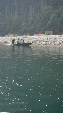 Dawki, Meghalaya,India-December 02 2023: Tourists boating in Dawki river Dawki or Umngot River, located at Meghalaya,India clipart