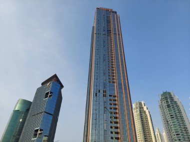 Modern corporate buildings against blue sky. High-rise buildings in Jakarta. Blue colored skyscrapers of business center.