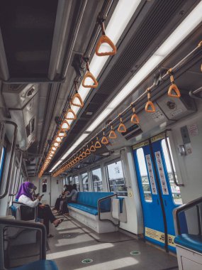 Palembang, Indonesia, June 16, 2022 : Commuters on Mass Rapid Transit (MRT) train. MRT is the latest public transportation system. MRT is a transportation for future.