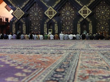 Muslim, prayer and mosque with a spiritual man group praying together during fajr, dhuhr or asr, otherwise maghrib or ishaa. Salah, worship and pray with islamic friends observing ramadan tradition