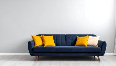 Modern ve davetkar bir yaşam alanı yaratın. İçinde moda sarı ve krem yastıklar bulunan bu şık mavi kanepe, iç mimari projeler için mükemmel..