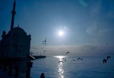 15 Temmuz Şehitler Köprüsü (Boğaz Köprüsü), sis bulutlarında martı ve gün doğumuyla birlikte görülüyor. Ortakoy Camii 'nden sisli sabah manzarası ve 15 Şehitler Köprüsü. 