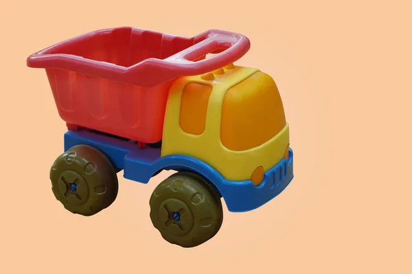 Zijaanzicht Kleurrijke Plastic Vrachtwagen Speelgoed Oranje Achtergrond Object Speelgoed Spelen — Stockfoto