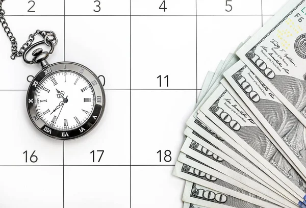 Pocket watch with money on the calendar. Time is money.