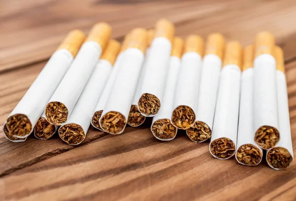 Cigarettes on wooden table.