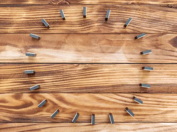 stock image Circle of dominoes, which stay on wooden background. Top view.