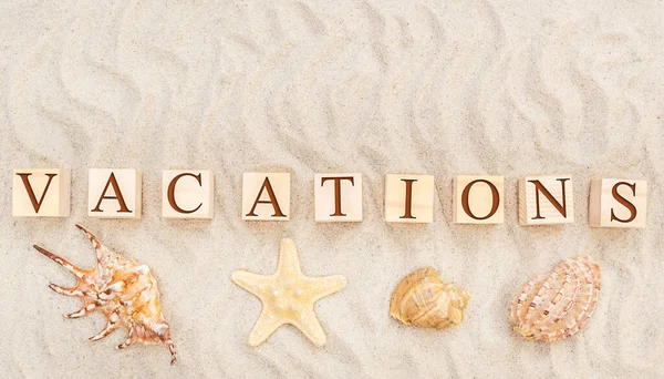 Wooden Cubes Word Vacations Seashells Sand Top View — Stock Photo, Image