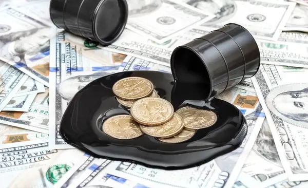 stock image Coins in spilled crude oil on background of dollar bills. Business concept.