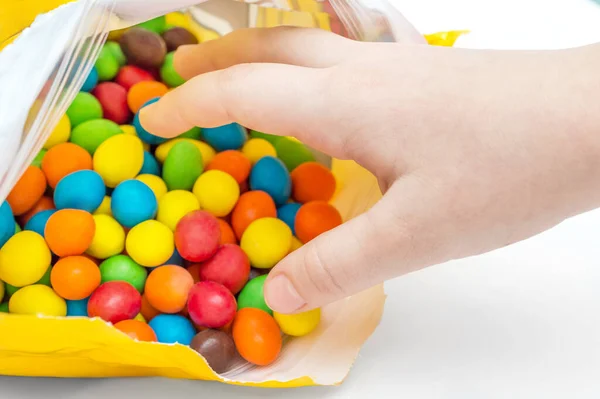 Child Hand Takes Colorful Candies Packet — Stock Photo, Image