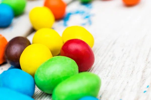 stock image Sweet round colorful candies on the old table. Close up.