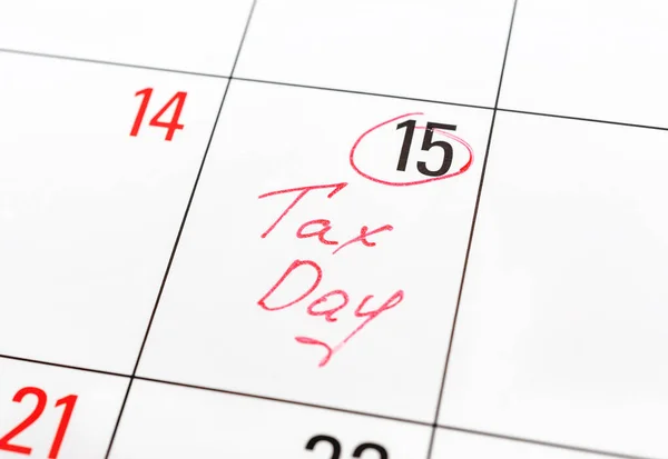 Tax day written on the calendar and circled 15th day by marker. Tax pay Deadline concept.