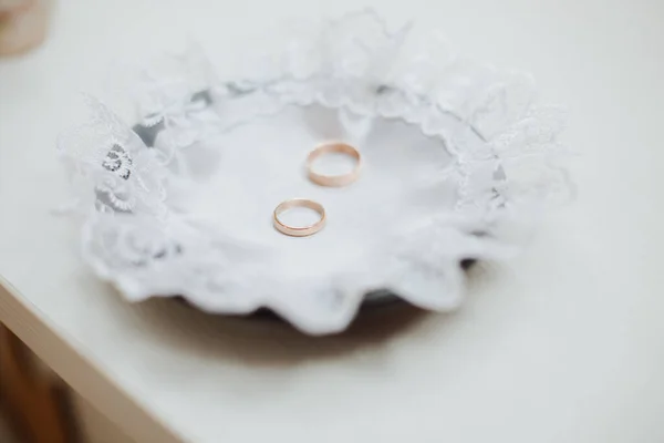 Wedding ceremony, two gold wedding rings on a bowl