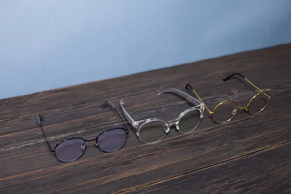 Glasses Thin Black Transparent Gold Frame Dark Background Wood Texture — Stock Photo, Image