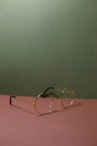 glasses in a thin frame on a plain background