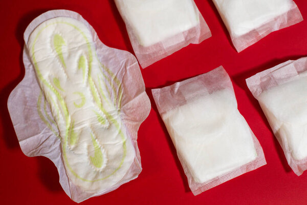 Female intimate hygiene, pads on a red background