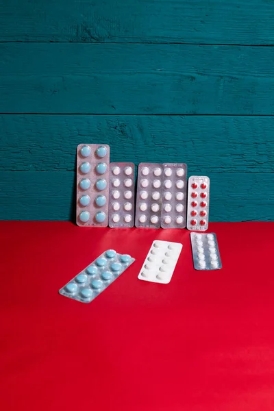 plates with pills on a blue-red background