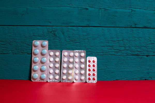 plates with pills on a blue-red background