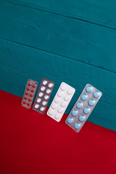 stock image plates with pills on a blue-red background