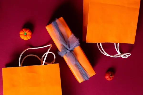 Little pumpkin with packages and gifts for Halloween