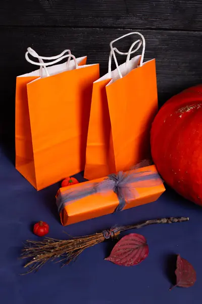Pumpkin with broom bags and a gift for Halloween