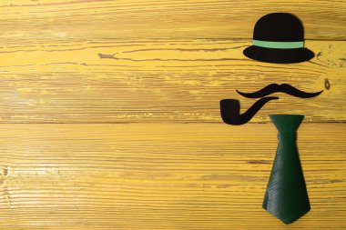 Sarı arka planda kağıttan yapılmış bir beyefendinin görüntüsü.