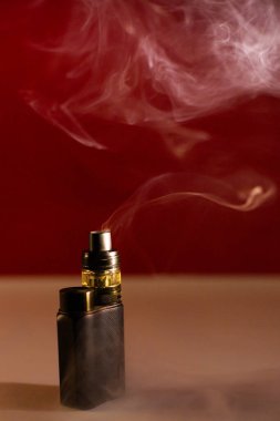 Güzel, koyu bir arka planda, dumanlı elektronik sigara.