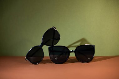 Güneş gözlüğü, yeşil arka planda kahverengi gözlükler.