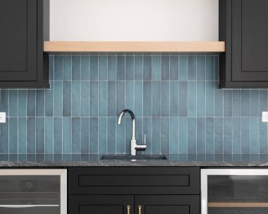 A faucet detail with black cabinets, a tiled backsplash with blue vertical subway tiles, wood shelves, and a black granite countertop.