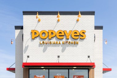 Romeoville, IL, USA - August 22, 2024: Popeyes Louisiana Kitchen, Inc. is a fried chicken restaurant with locations worldwide. clipart