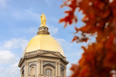 Notre Dame, IN, USA - October 25, 2024: University of Notre Dame is a private Catholic research university established in 1842. The Golden Dome is a historic landmark on campus at the main building. clipart