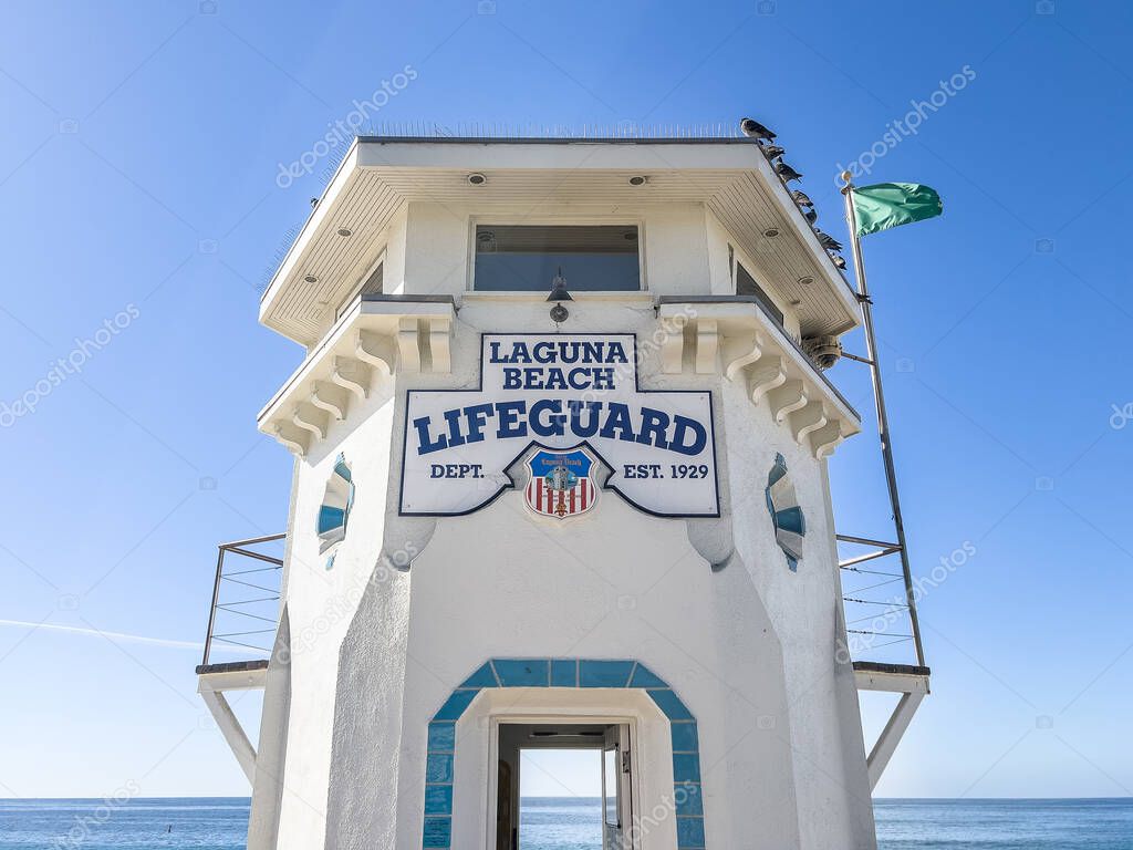 Laguna Beach, CA, USA - November 14, 2024: A Laguna Beach Lifeguard tower on the beach with the Pacific Ocean in the background.
