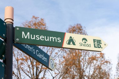 Chicago, IL, USA - December 17, 2024: A sign on the Museum Campus of downtown Chicago pointing towards the Adler Planetarium, Shedd Aquarium, and Field Museum. clipart