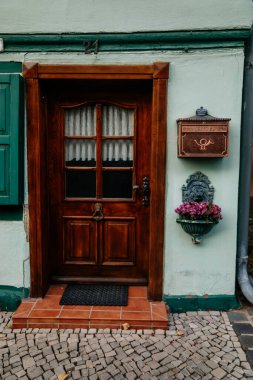 Quedlinburg, Saxony-Anhalt, Germany, 28 October 2022: Wooden carved vintage door with mailbox, antique house in medieval town, Typical beautiful streets of the ancient city, Entrance of apartment 