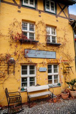 Quedlinburg, Saxony-Anhalt, Germany, 28 October 2022: Historic old vintage colored timber frame houses in medieval town, UNESCO World Heritage city, half-timbered home at sunny autumn day, cobblestone