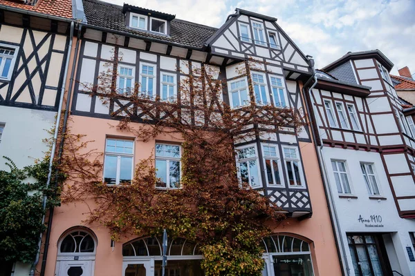 Wernigerode, Saxony-Anhalt, Germany, 29 October 2022: Historic old vintage colored timber frame houses in medieval town, UNESCO World Heritage city, half-timbered home at sunny autumn day, cobblestone