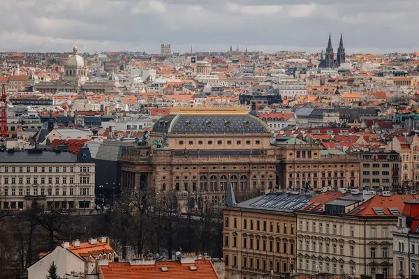 Prag, Çek Cumhuriyeti, 26 Mart 2023: Petrin Tepesi 'nden eski şehrin panoraması, Kızıl çatılar, Güneşli bahar günü, Vltava nehir seti, Ulusal Tiyatro, Yüksek kuleler gotik kuleler, kentsel manzara