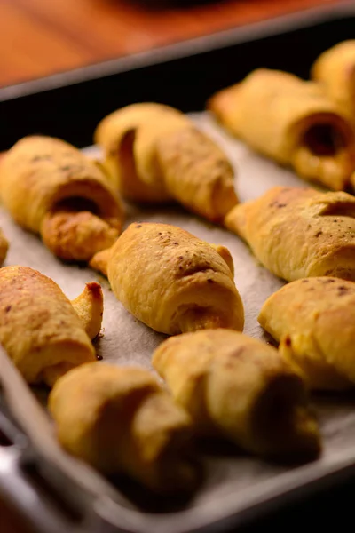 Stock image Just out of the oven, freshly baked mini croissants with a crispy crust. Homemade puff pastry. Bakery of croissants with various fillings. Recipes for baking.