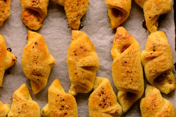 stock image Just out of the oven, freshly baked mini croissants with a crispy crust. Homemade puff pastry. Bakery of croissants with various fillings. Recipes for baking.