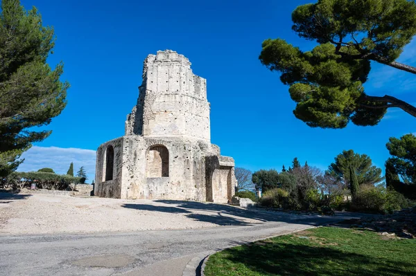 Nimes, Occitanie, France, 12 31 2022 - The historical Magne tower and gardens against a blue sky