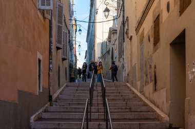 Marseille, Provence, France, 12 31 2022 - Stairs between rows of yellow houses in old town
