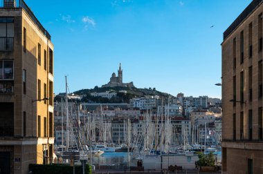 Marseille, Provence, France, 12 31 2022 - High angle view over the old port and the Basilica of the Notre Dame de la Garde