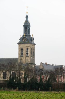 Kessel-Lo, Flemish Brabant, Belgium - Feb 11 2023 - The Park abbey tower and green surroundings around the railway station