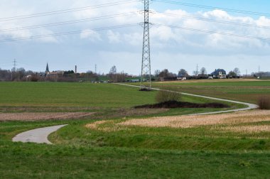 Bending road through the agriculture fields at Relegem, Flemish Brabant Region, Belgium